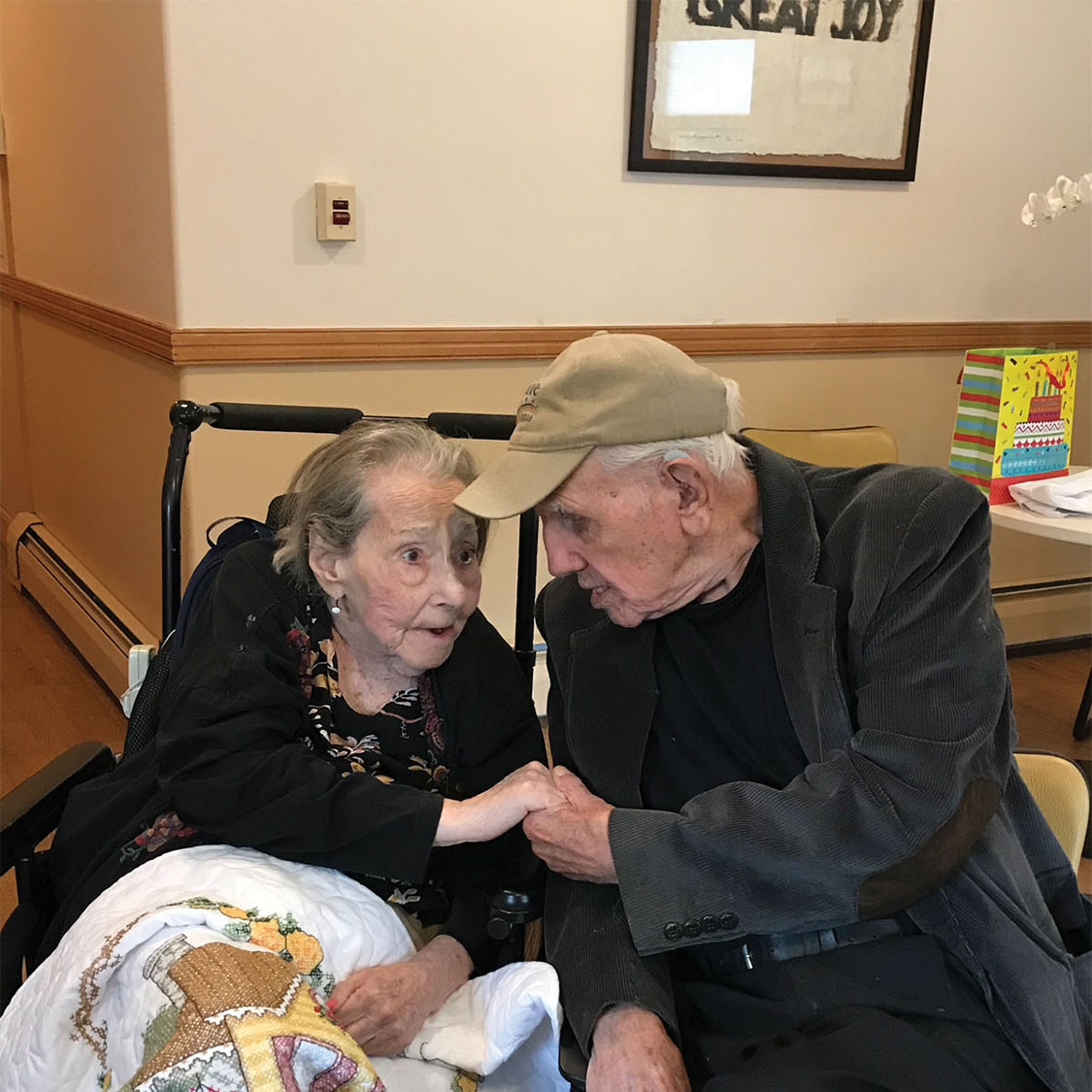 Elderly couple sitting together