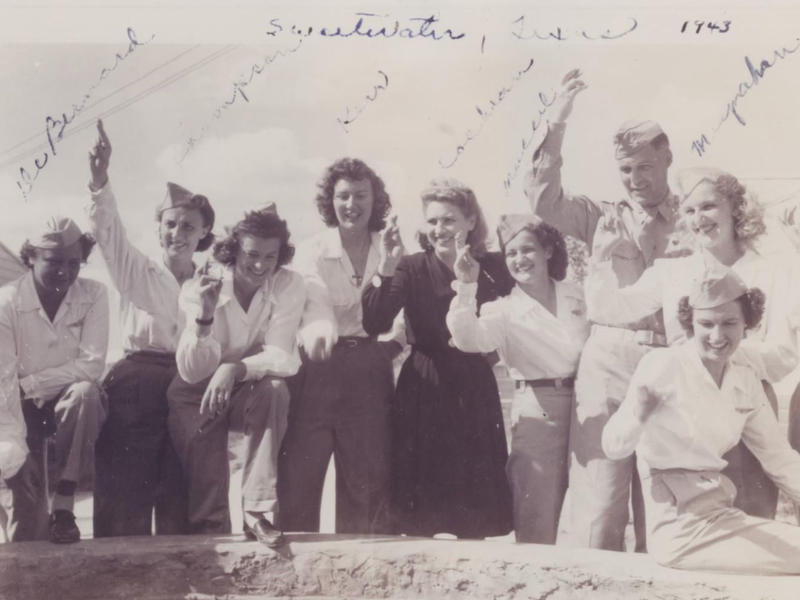 1943 photo of several women in military uniforms waving
