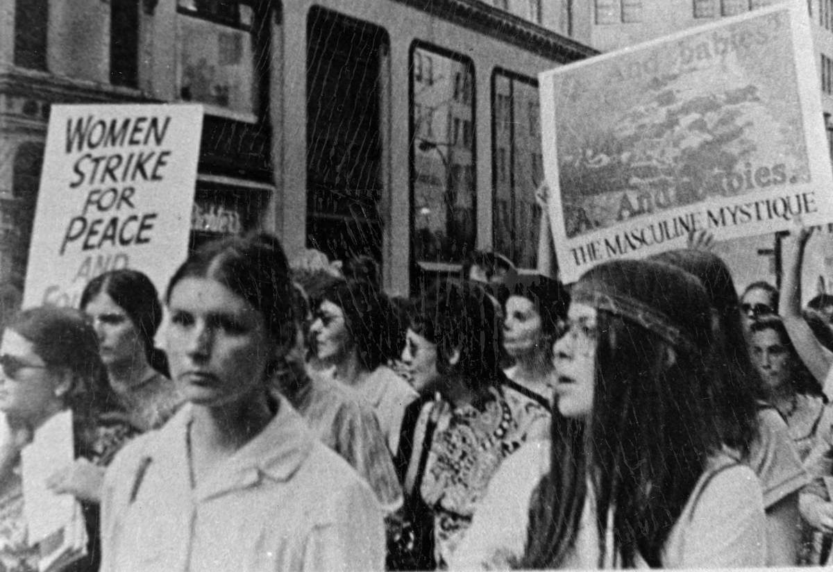Woman peacefully marching and protesting in the 1960s or 1970s