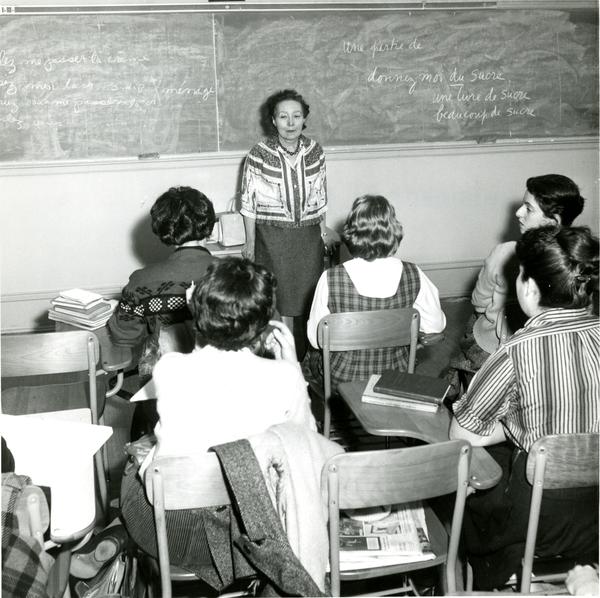 Female teacher instructs room of female students