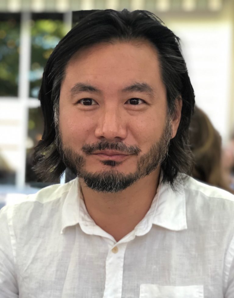 Image of an Asian man with shoulder length hair: Ken Chen, Associate Director of Creative Writing
