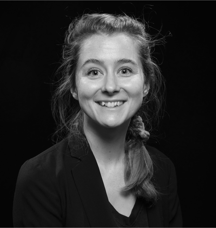 Headshot of Amy LaViers facing the camera and smiling, in black and white