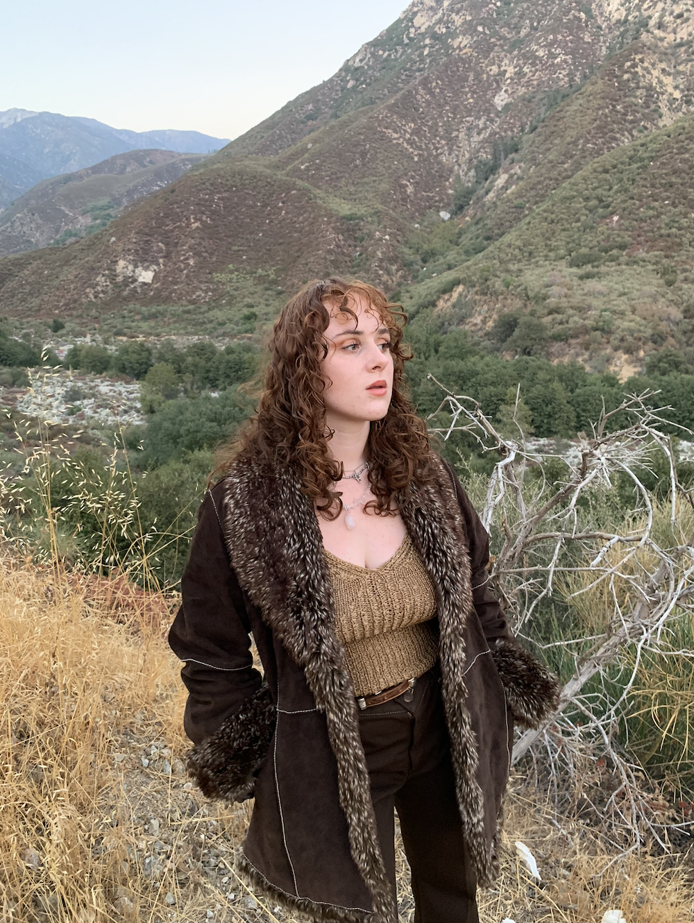 A medium shot of Madison O'Halloran outdoors in a brown fur coat