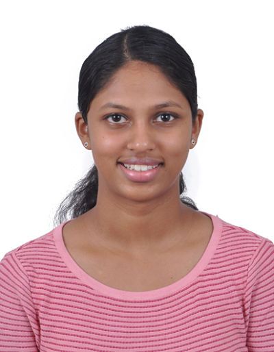 Diksha pictured wearing a pink shirt against a white background.