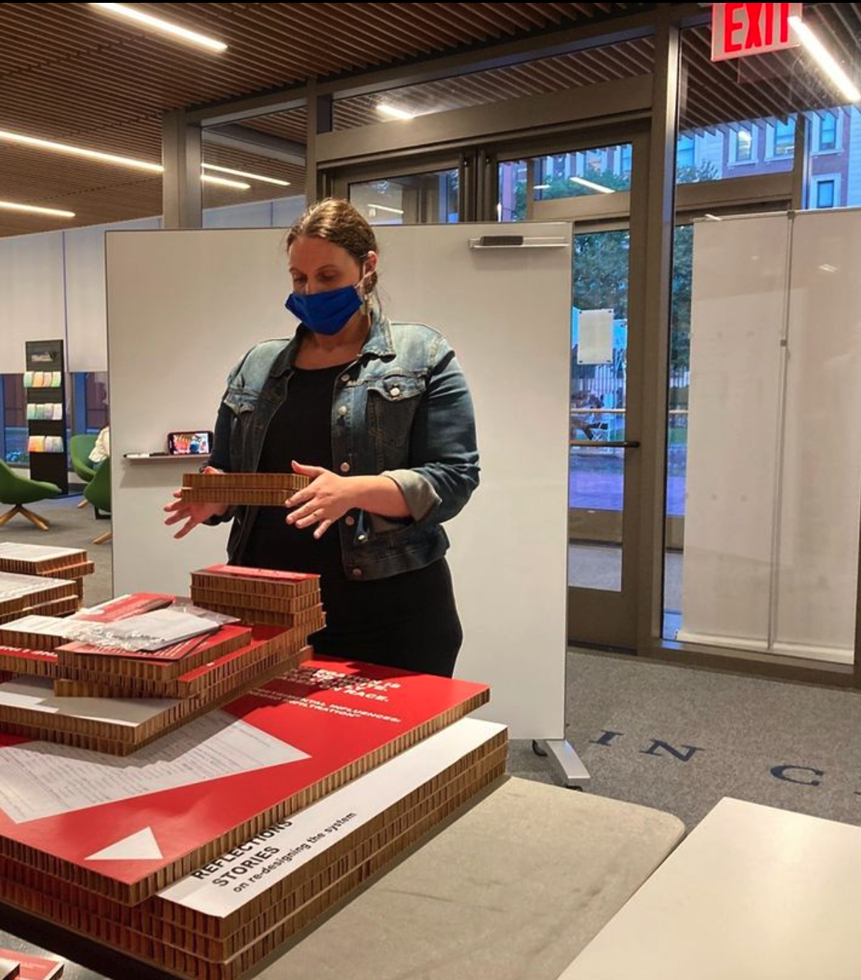Mary Rocco preparing boards to be installed for the Undesign the Redline exhibit in the Milstein lobby