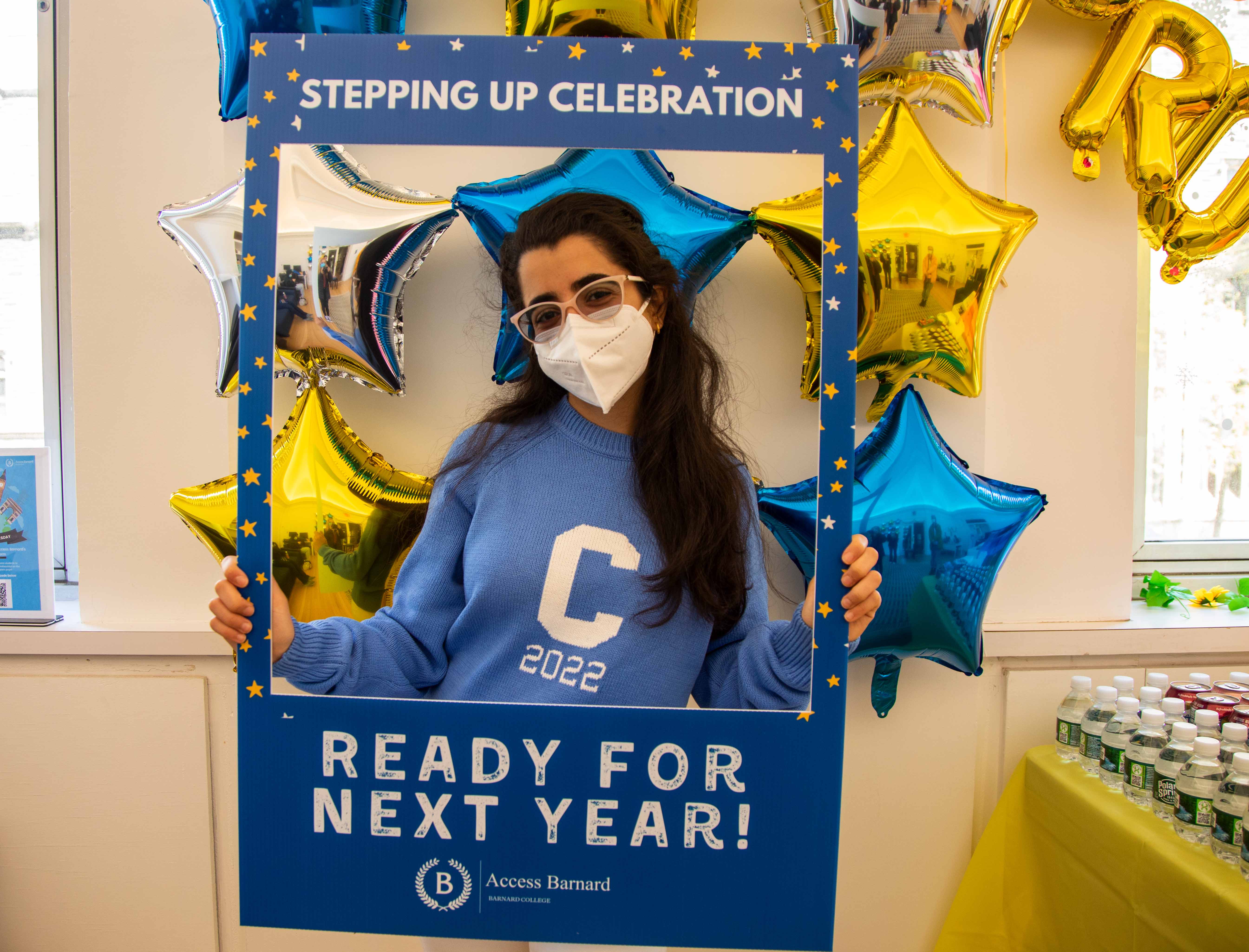 Student at the Access Barnard Celebration holding a blue cardboard cutout around herself that says, "Ready for next year!"