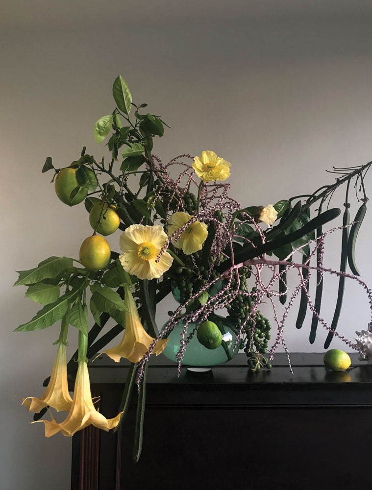 floral arrangement with lemons and yellow flowers