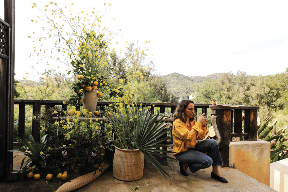 Sophia Moreno-Bunge ’09 taking a photo of a floral arrangement