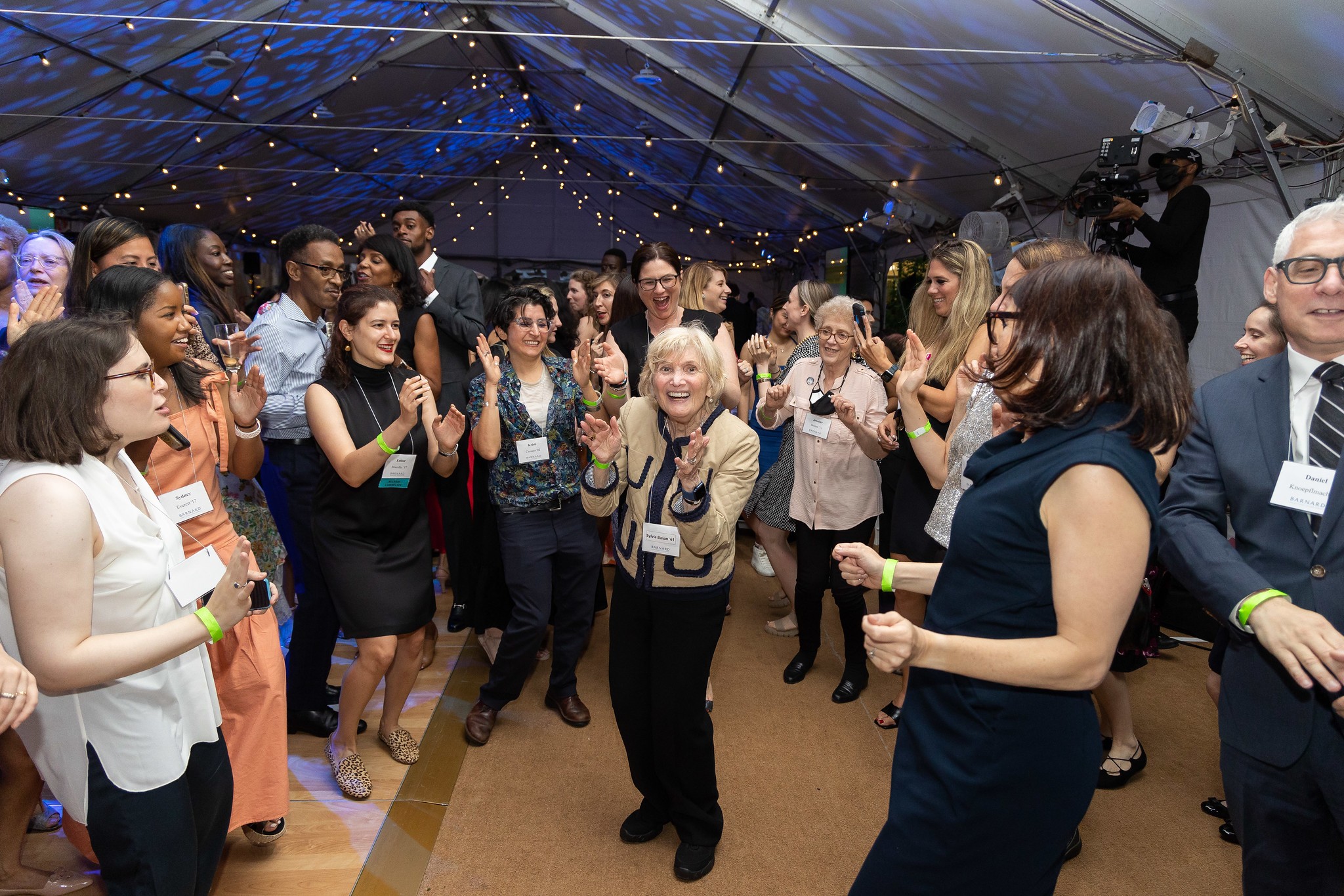Alumnae and attendees dancing under Futter Field tent 