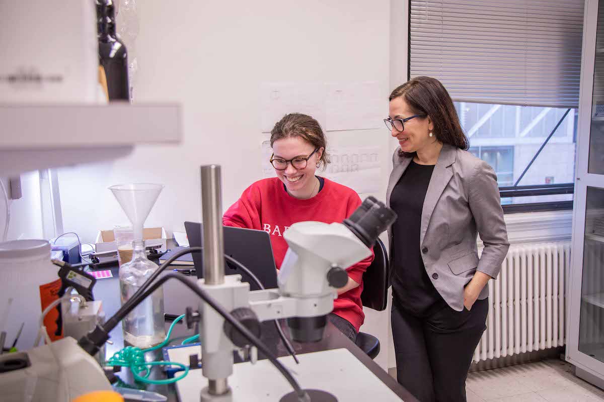 Teacher and student wearing red Barnard sweat shirt in the lab