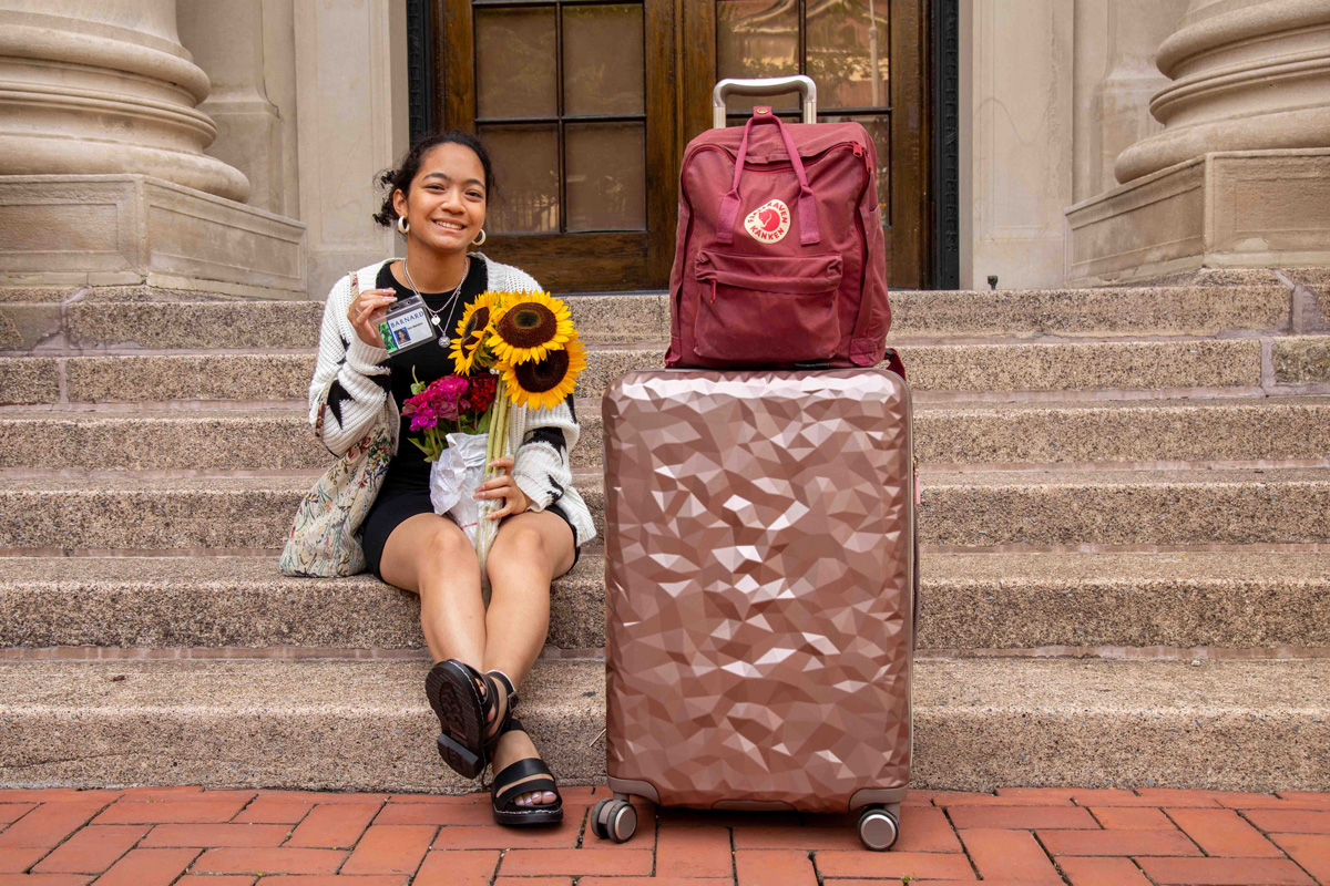 2023-New-student-move-in-steps-of-Barnard-Hall with suitcase
