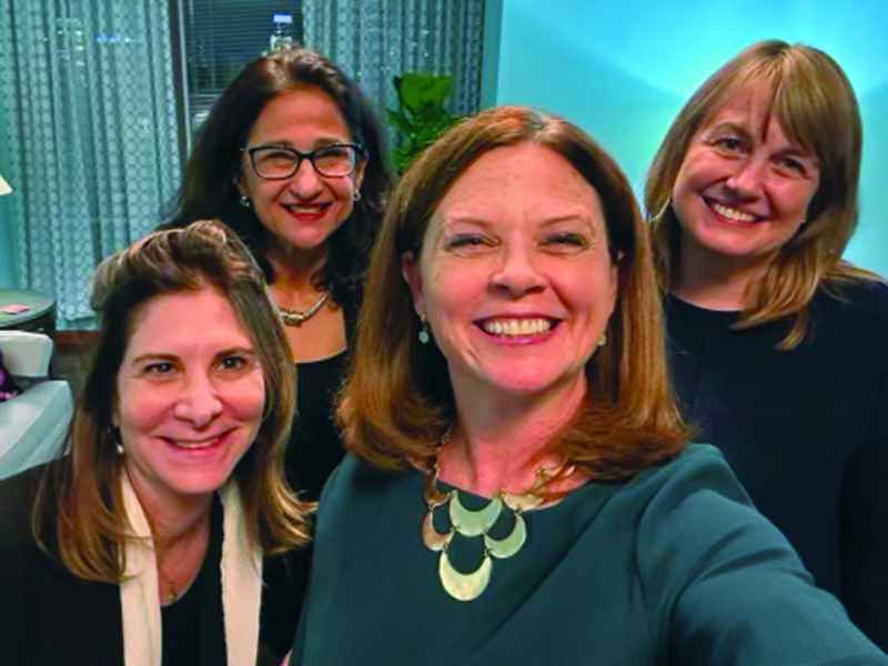 A selfie of four women university presidents from New York City