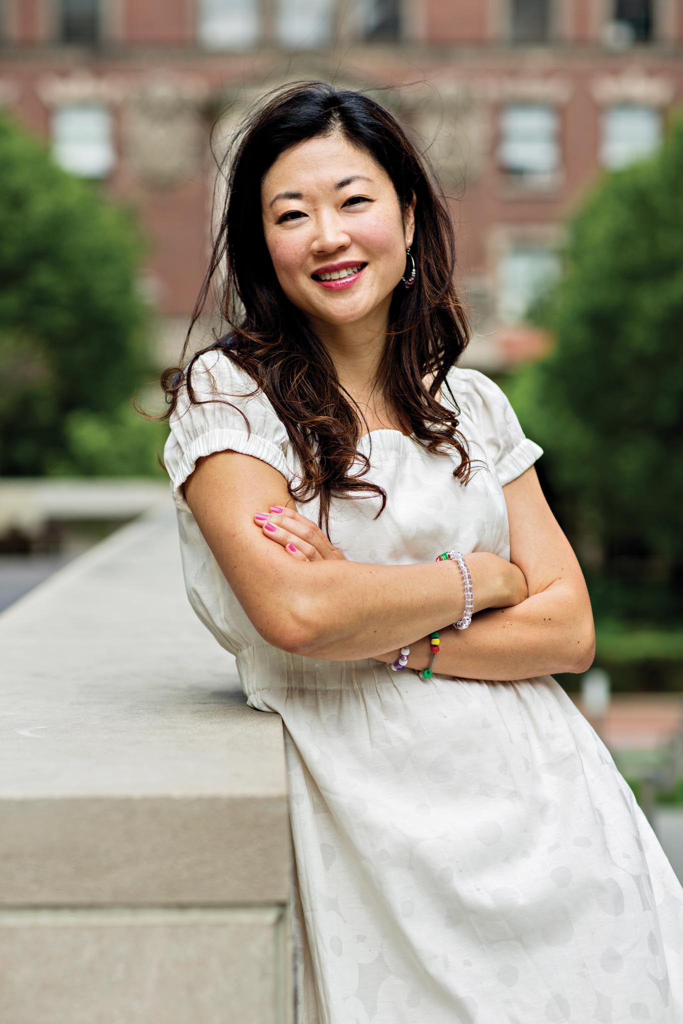 Sooji Park headshot on campus. She is wearing a white dress and has her arms crossed