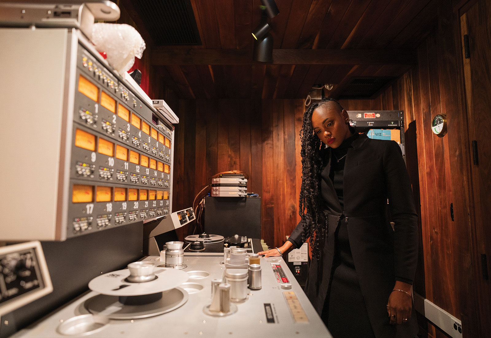 Ebonie Smith stands at music control panel