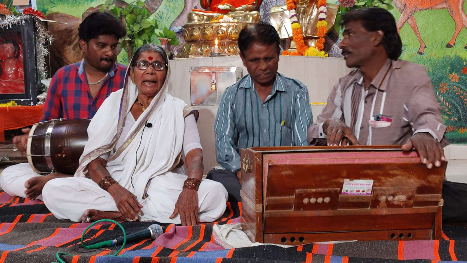 Elderly woman sings anti-caste songs with three musicians