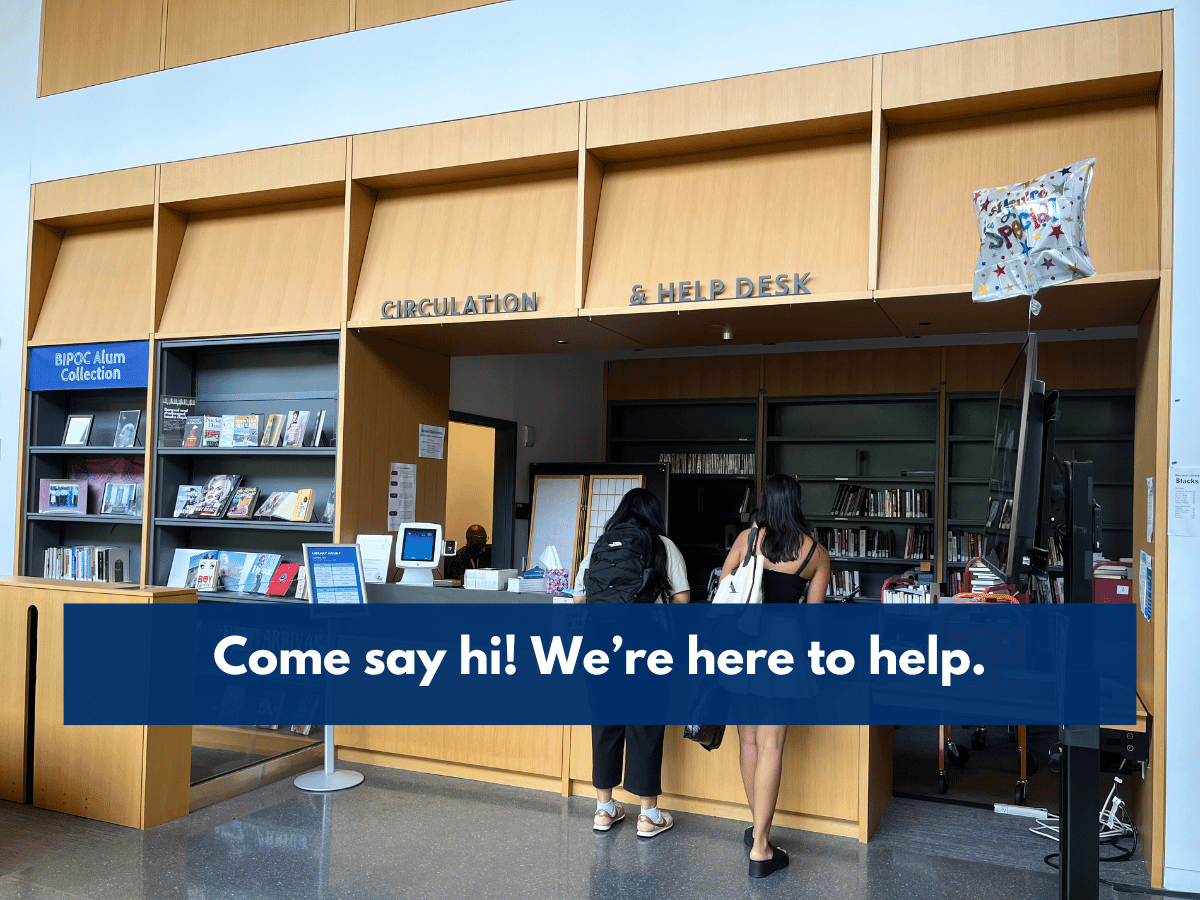 Image of patrons at the library circulation desk.