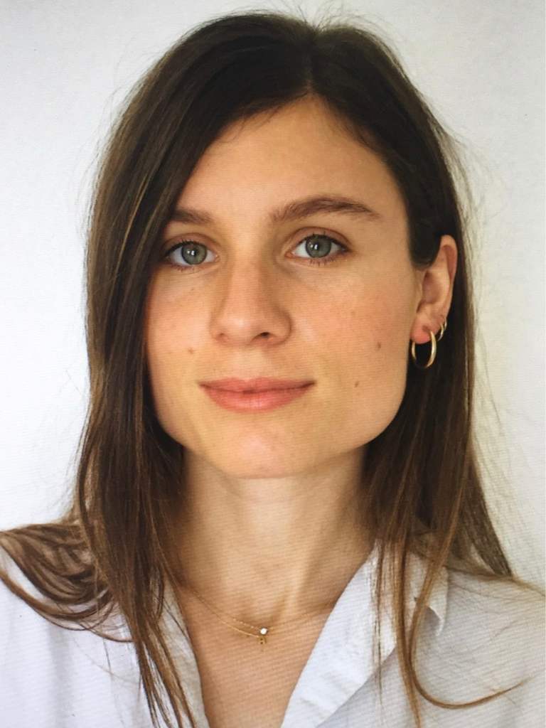 Headshot of Filmmaker Adriana Banta wearing a white button down shirt. 