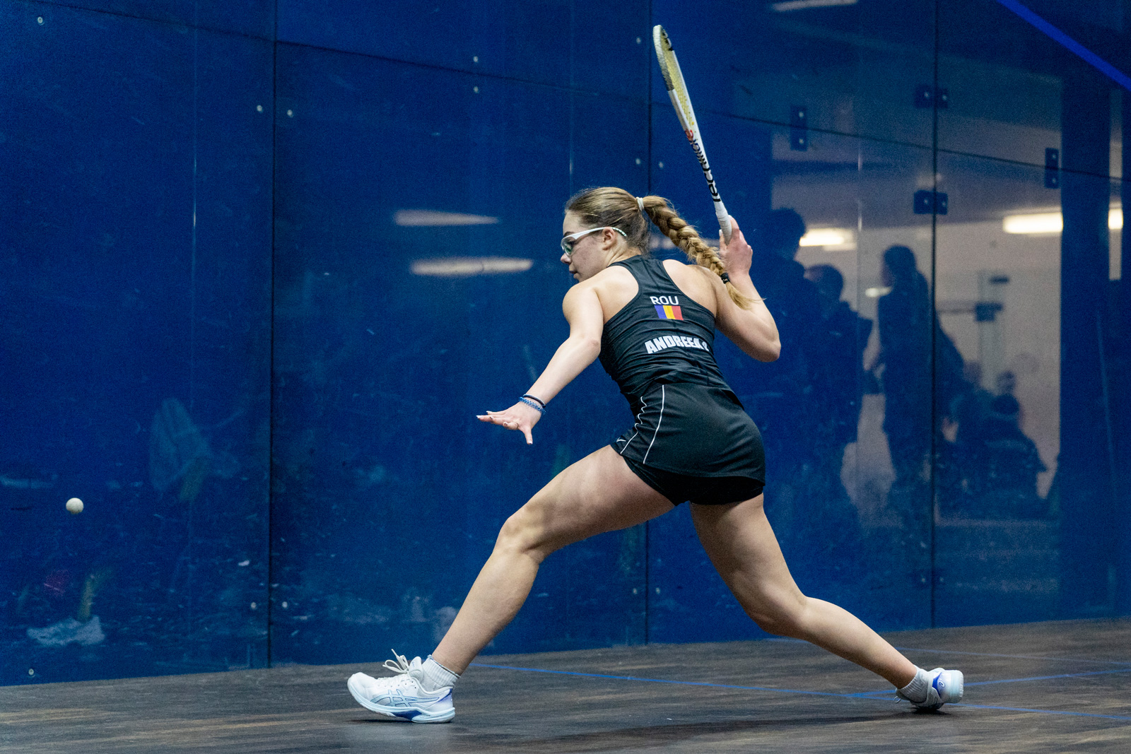 woman swinging squash racquet