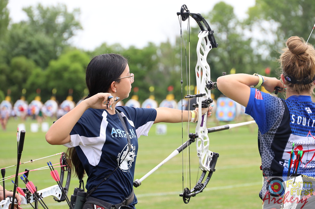 Young woman holding bow and arrow