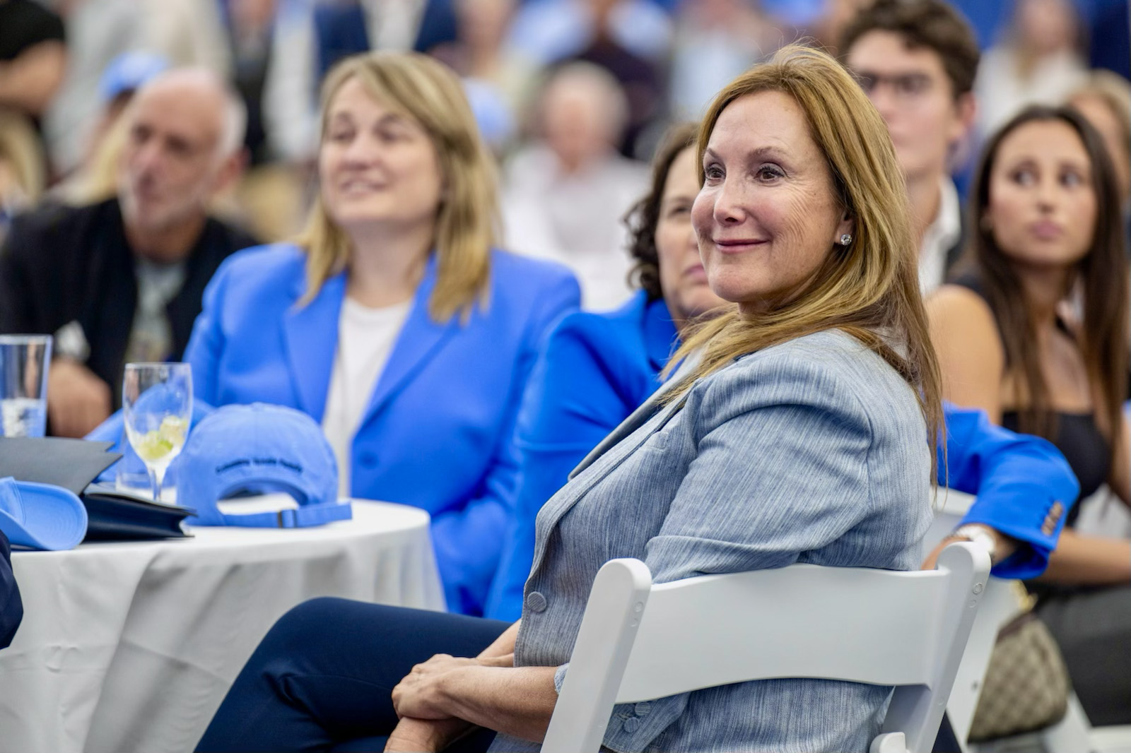 Woman seated wearing gray blazer