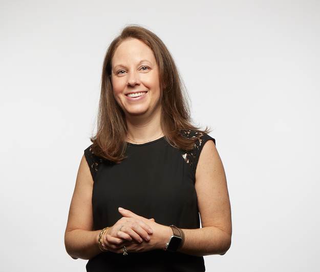 Woman with shoulder length brown hair wearing black top