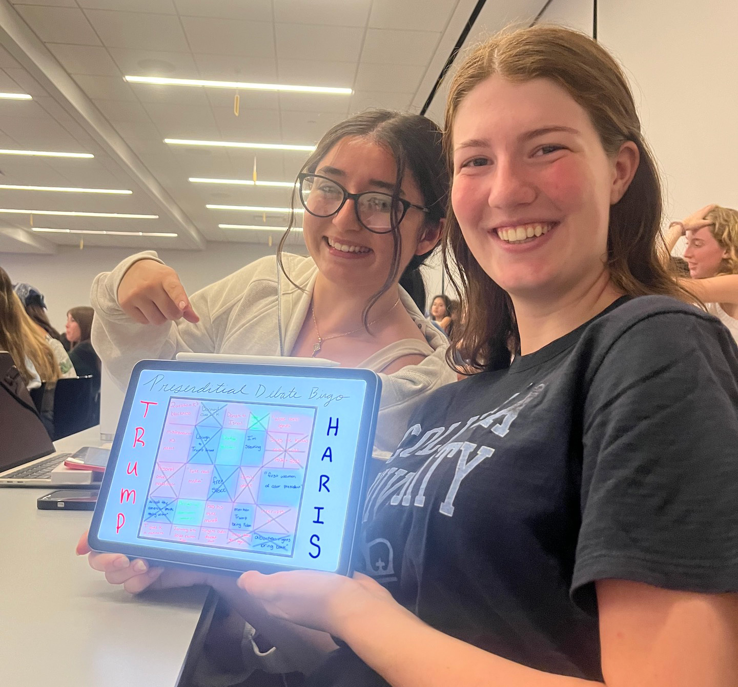 Students holding up debate bingo