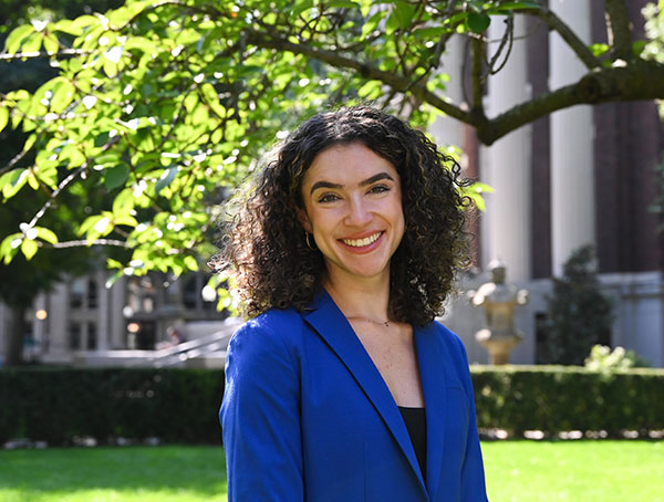 Woman with dark hair wearing a blue jacket