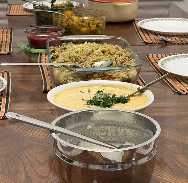 Various dishes in pots lined on a table