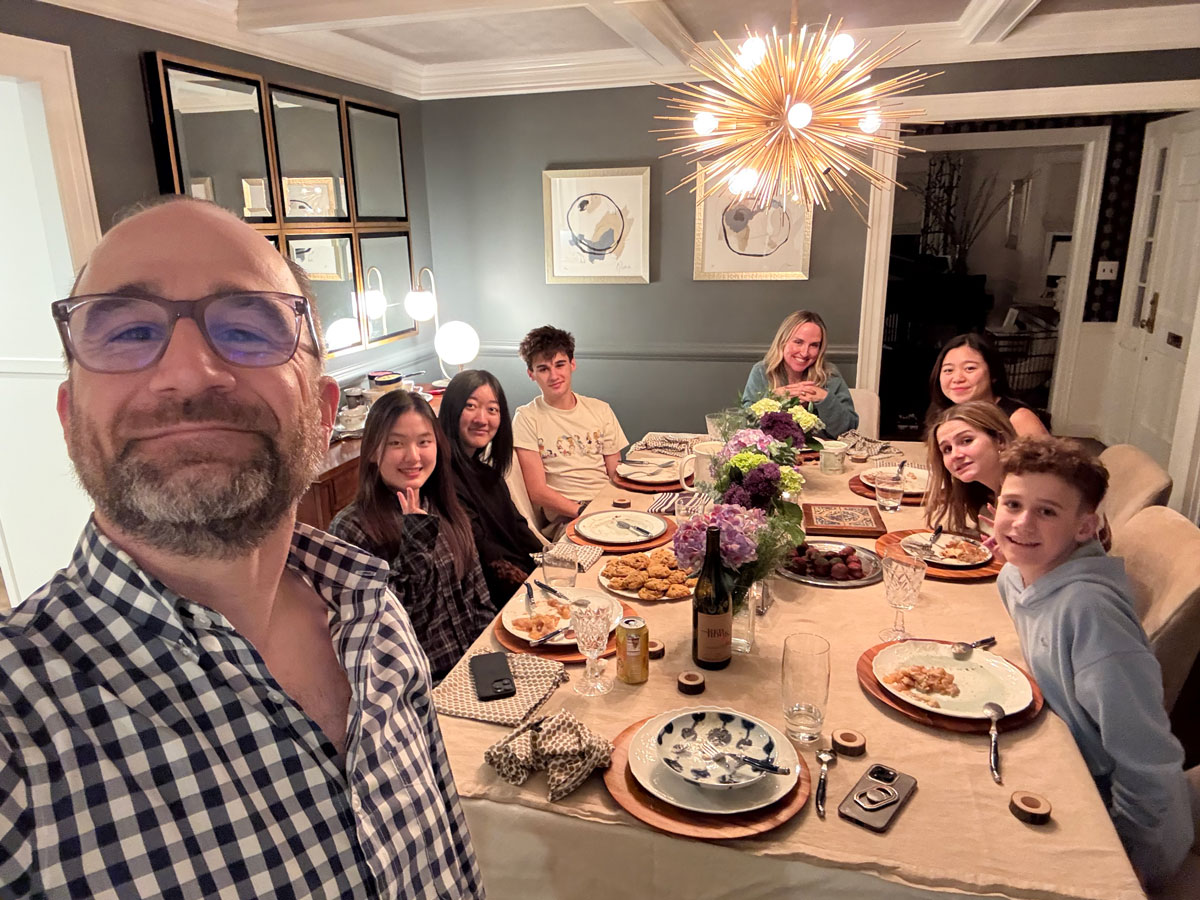 Group at a dinner table underneathe a chandelier