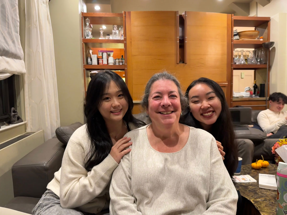 Three women smile for a photo