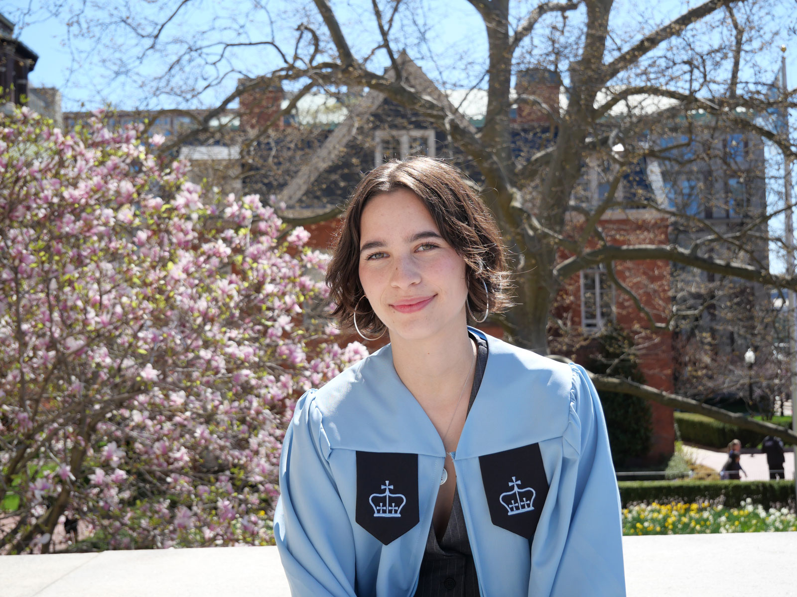 Woman wearing blue graduation gown