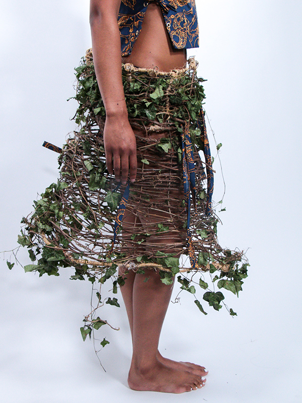 The start of reciprocity (2024) Chinese wisteria, wild grape, English ivy, hot glue, fabric gifted by artists Aunt Ernestine, and twine belonging to the artist’s late Uncle Cleveland. 48" x 28" x 28" inches