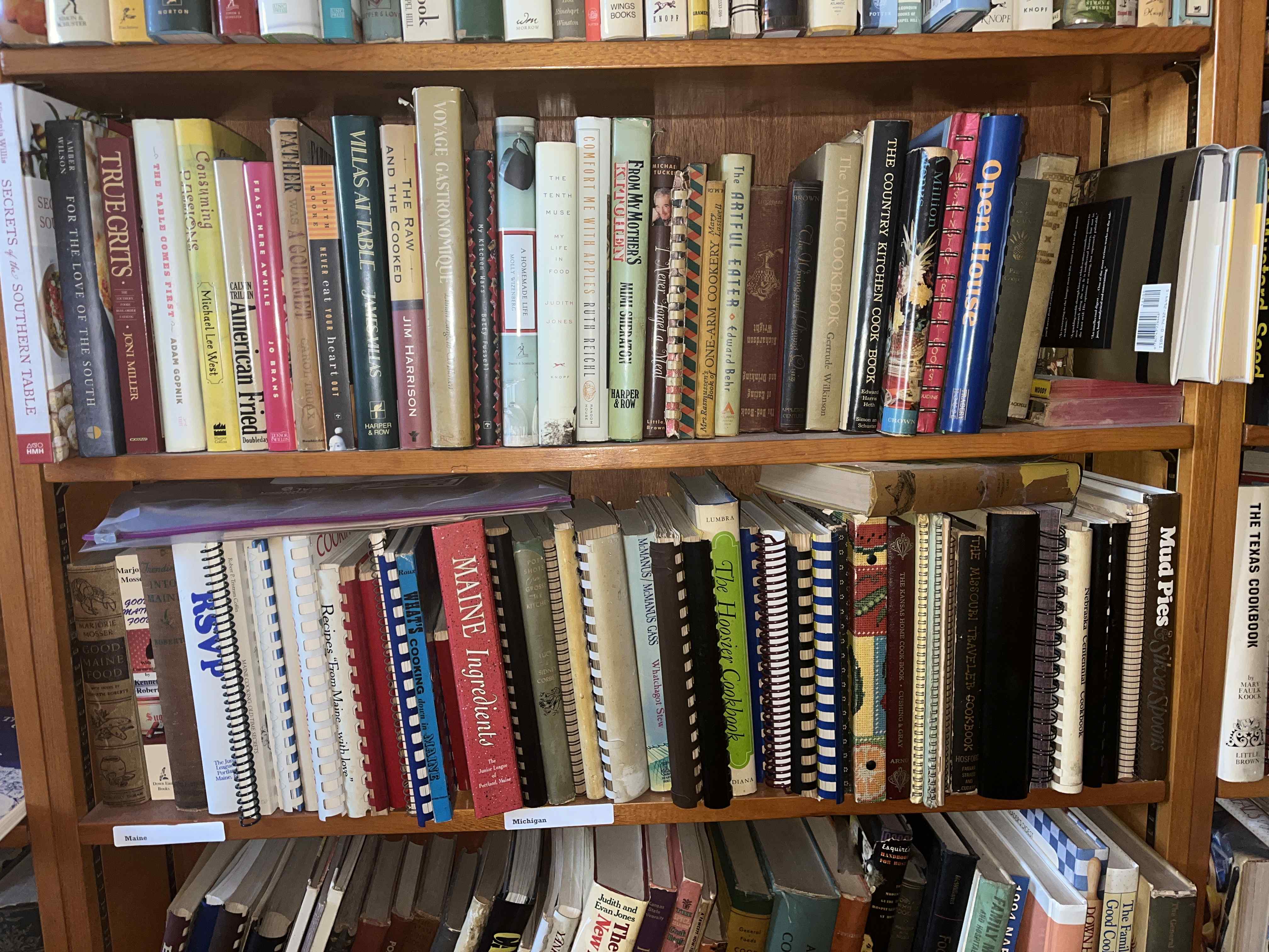 Bookshelf filled with cookbooks and books of food writing