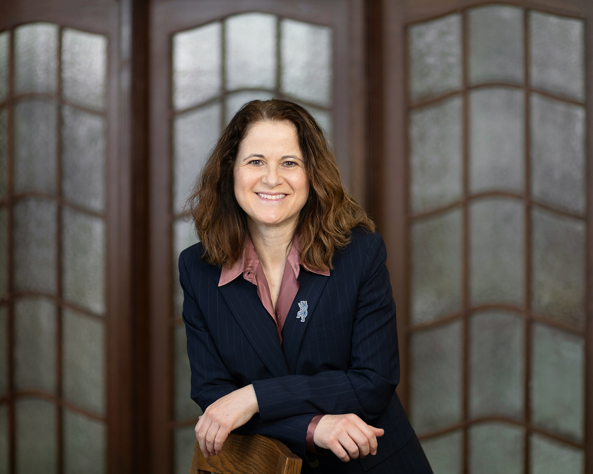 Photo of Rebecca Walkowitz leaning over a chair 