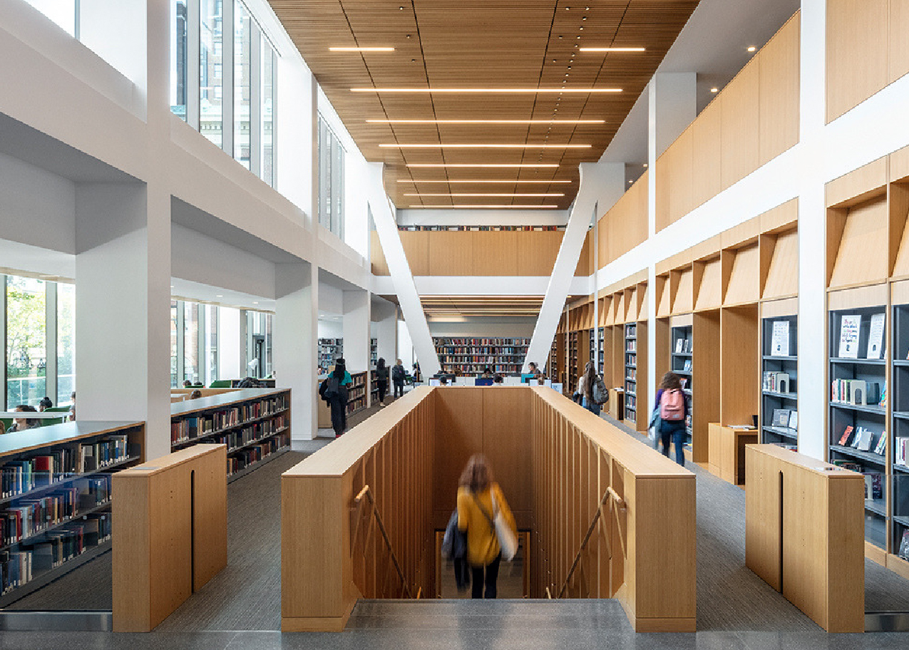 interior view of the library with someone walking down a staircase