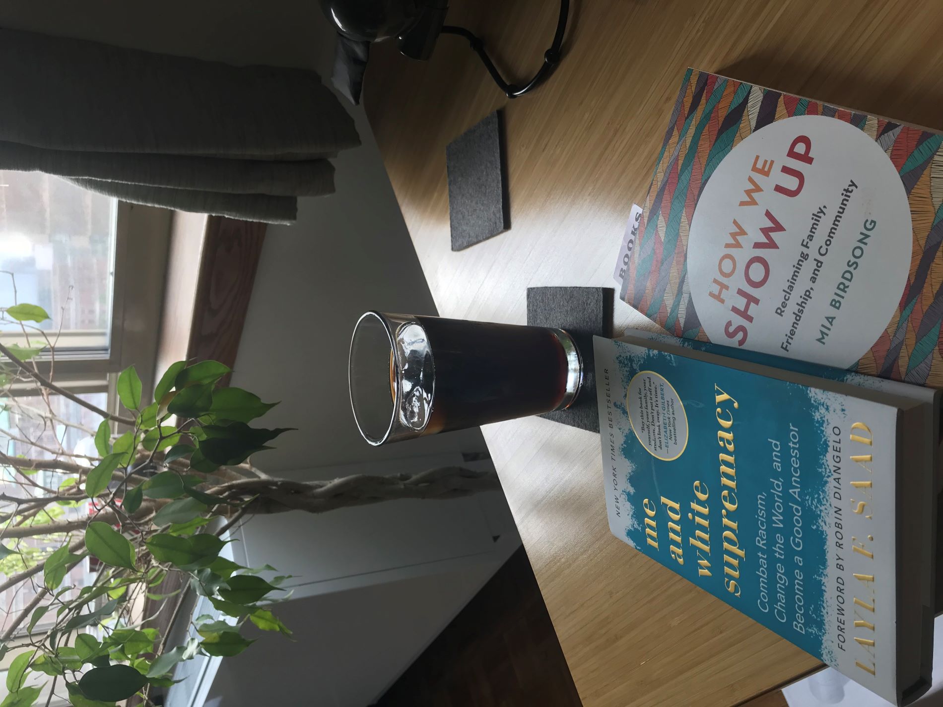 iced coffee on a desk with 2 books