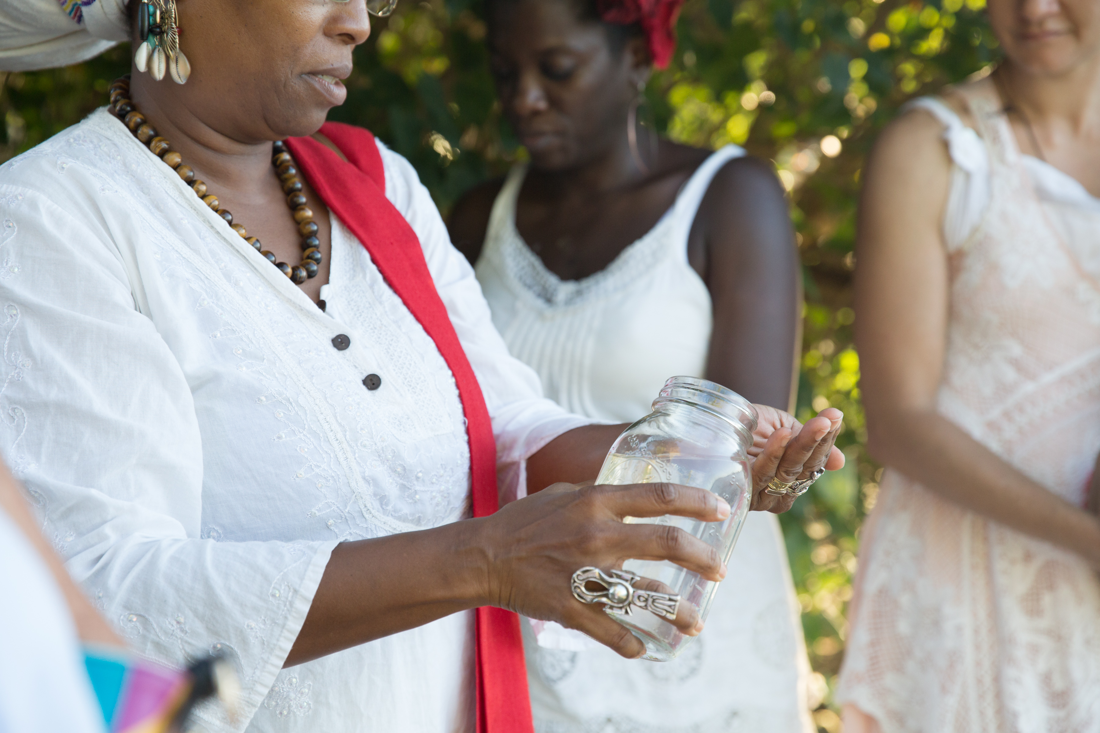 At the bayside in St. Croix, we passed a jar of sea water among us, each offering a wish or hope or blessing back to the sea. Dr. Chenzira Davis-Kahina pours water on her hands as part of her ritual. Fishtrap collaborator Oceana James and Paloma McGregor stand in the background.