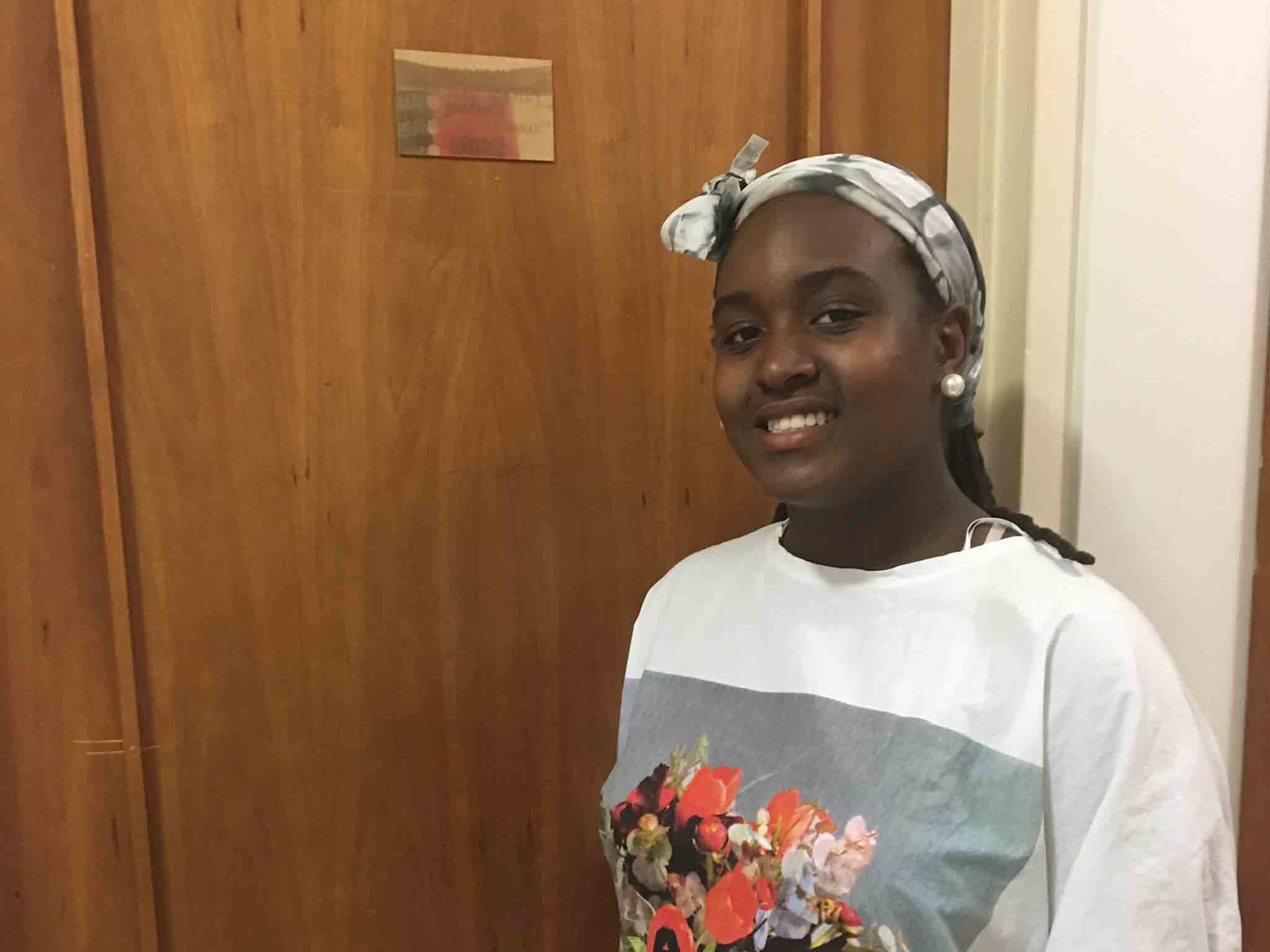 Young woman standing in front of a door