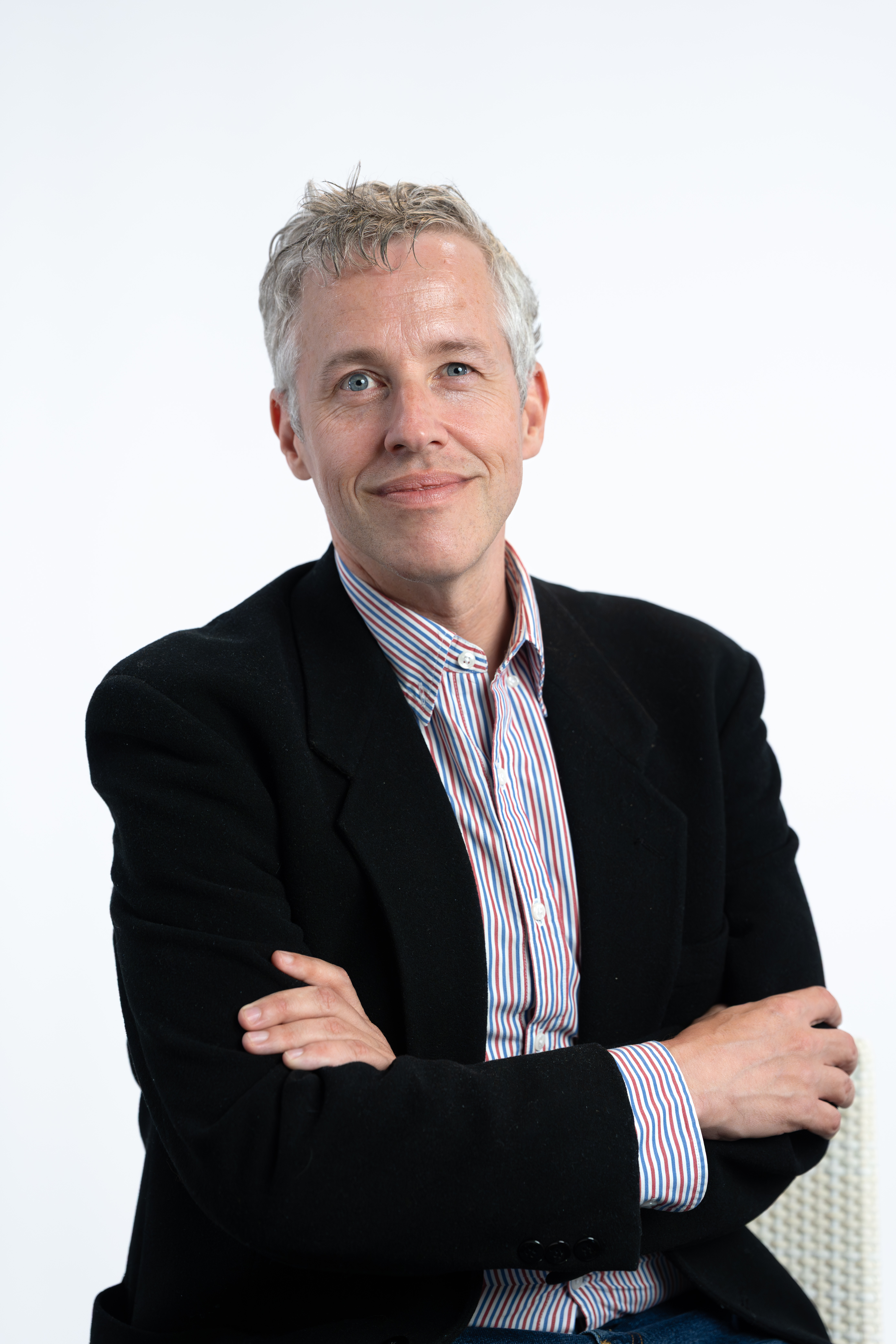 Professor crossing arms against white background. 