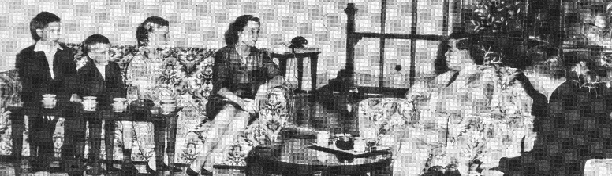 Colby on a couch in her living room with her three children, across from her husband and the president of Vietnam