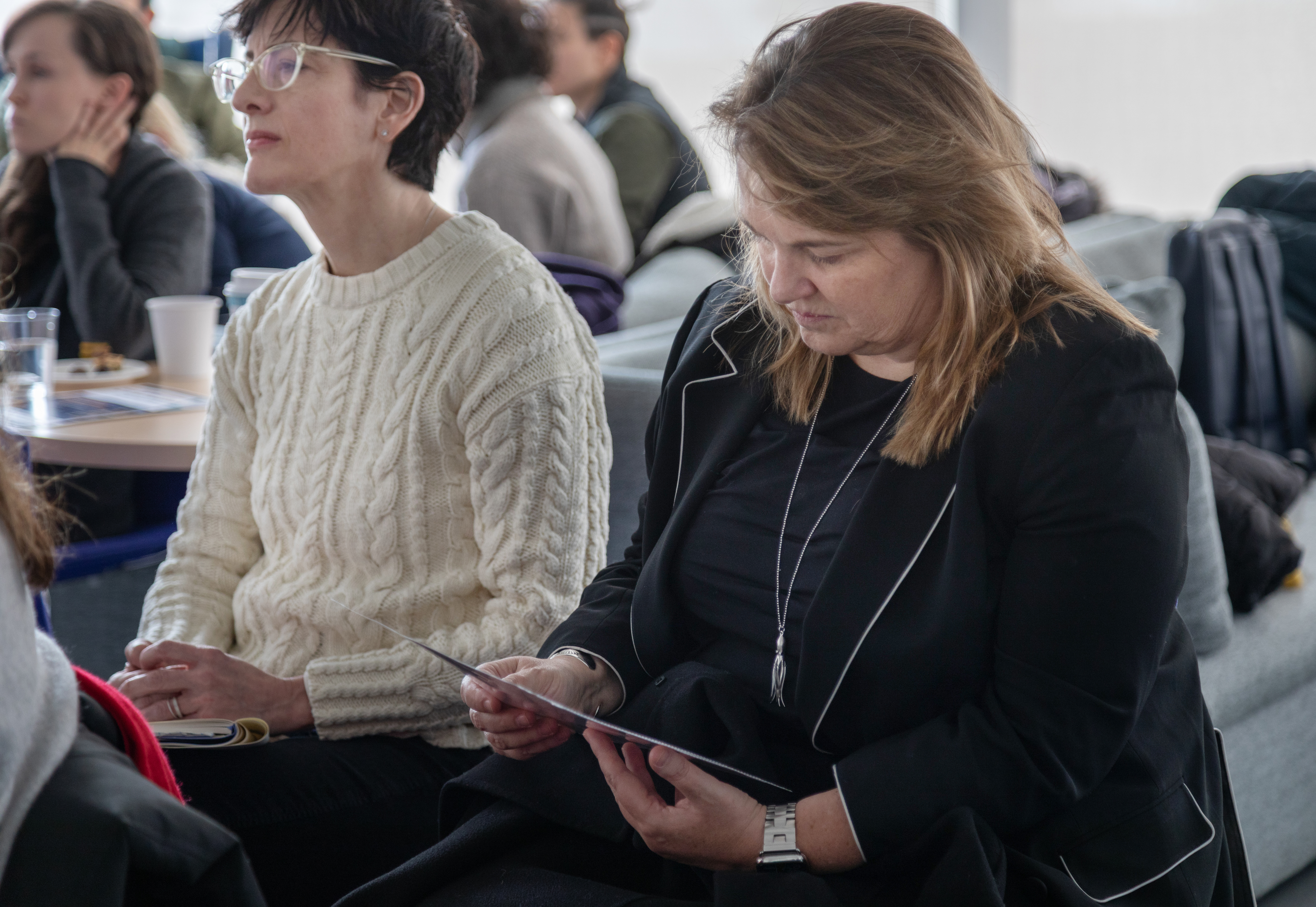 President Laura Ann Rosenbury looking at records at Brenner's faculty chat