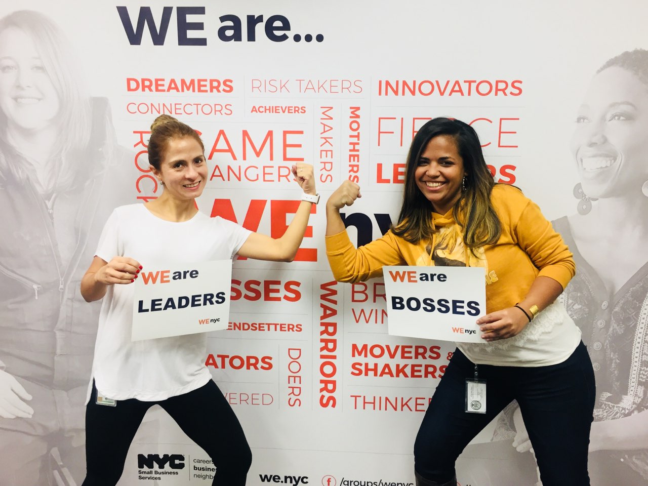 [Image description: Alex Ruiz and a colleague holding signs that say "We are leaders" and flexing their biceps]