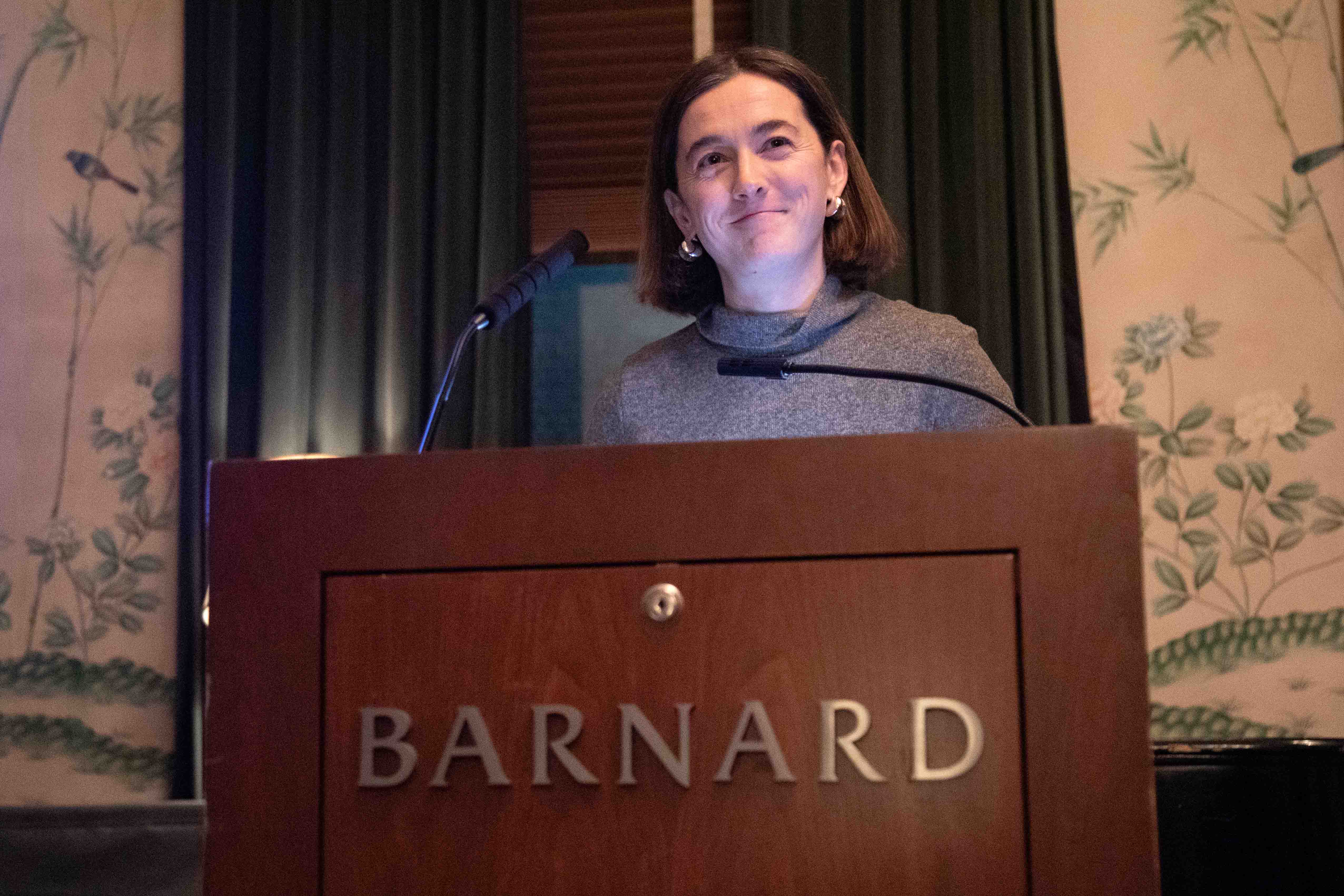 Woman stands at Barnard podium