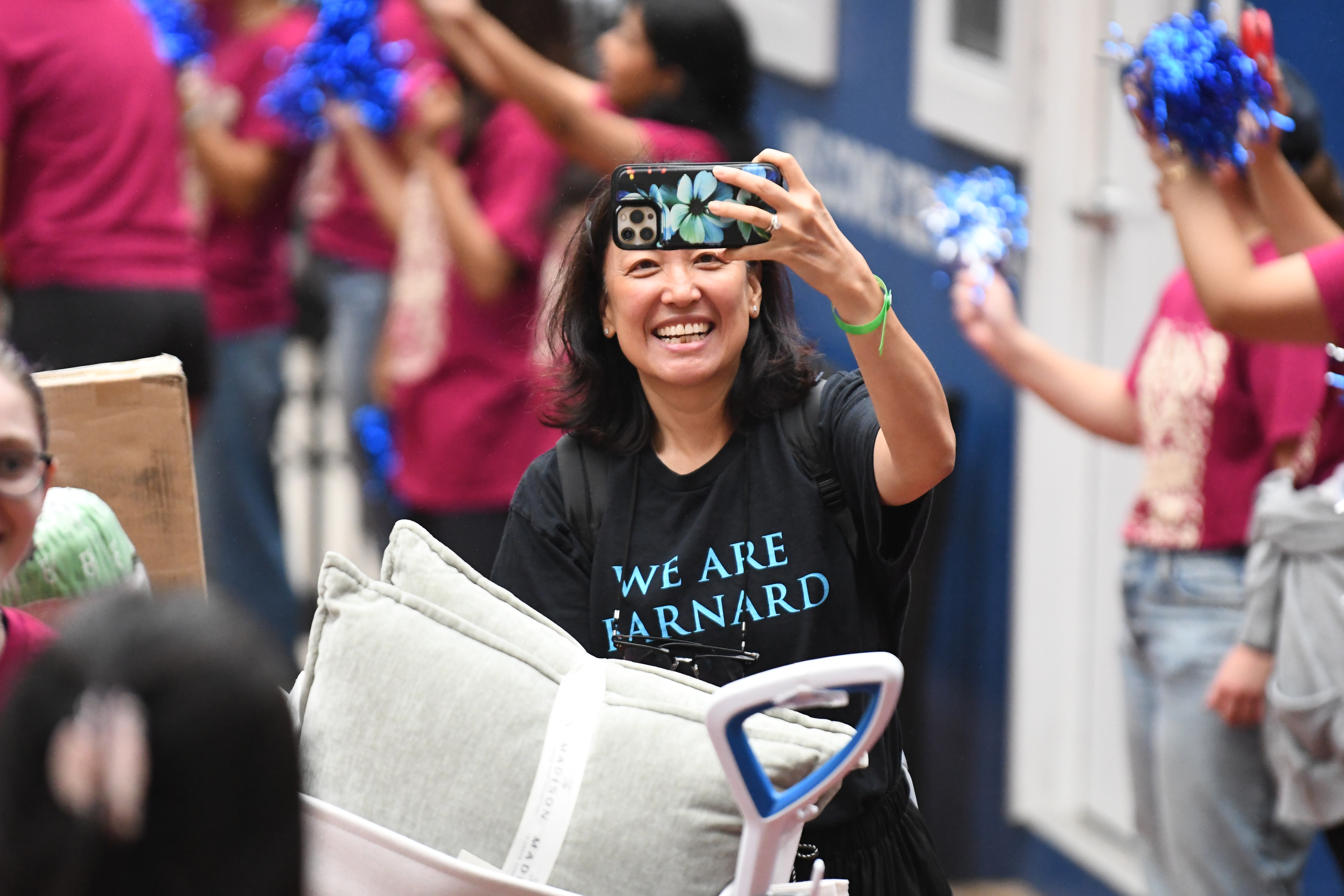 Woman smiles with phone.