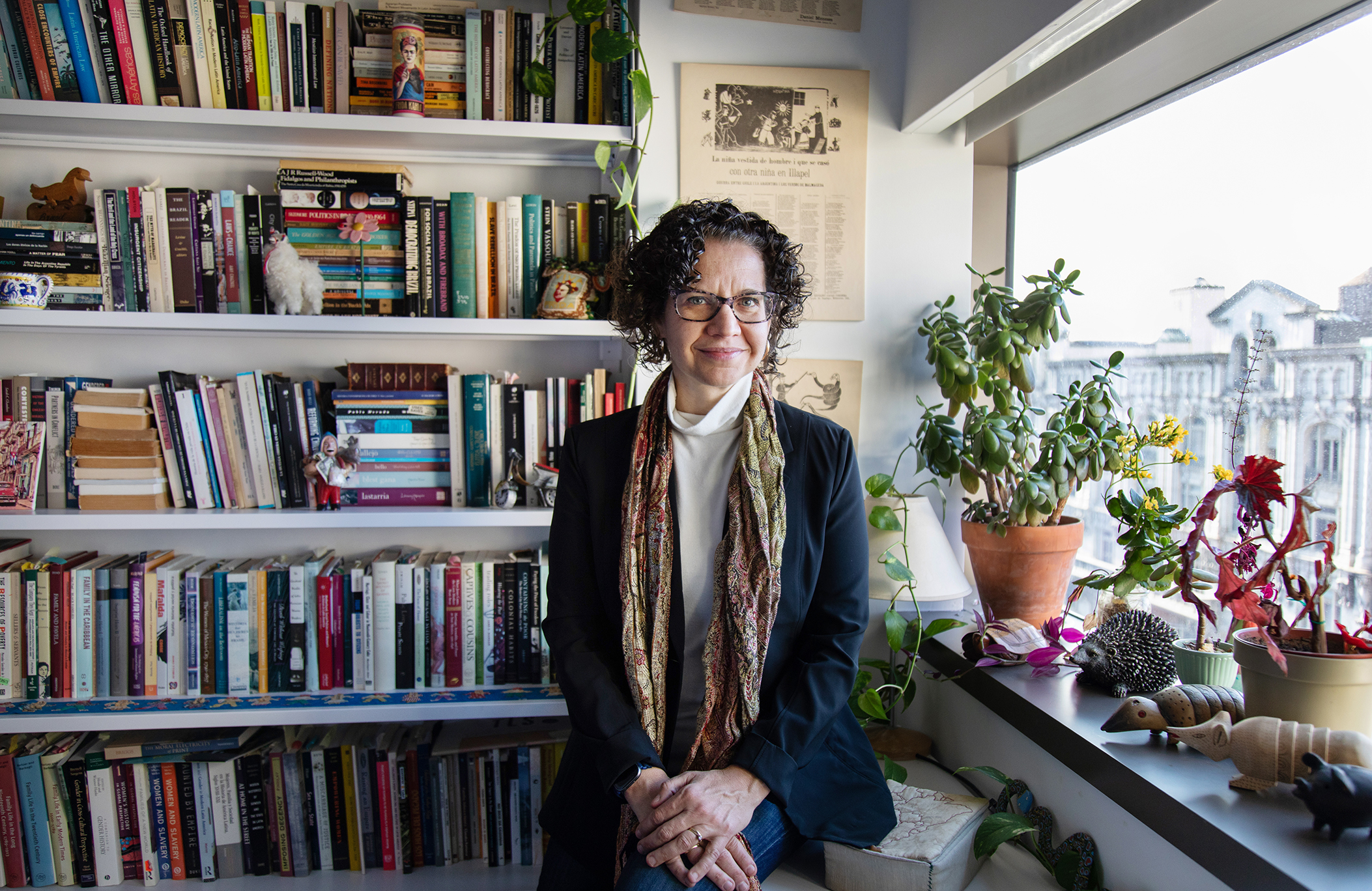 Wide shot of Nara Milanich standing in her office. 