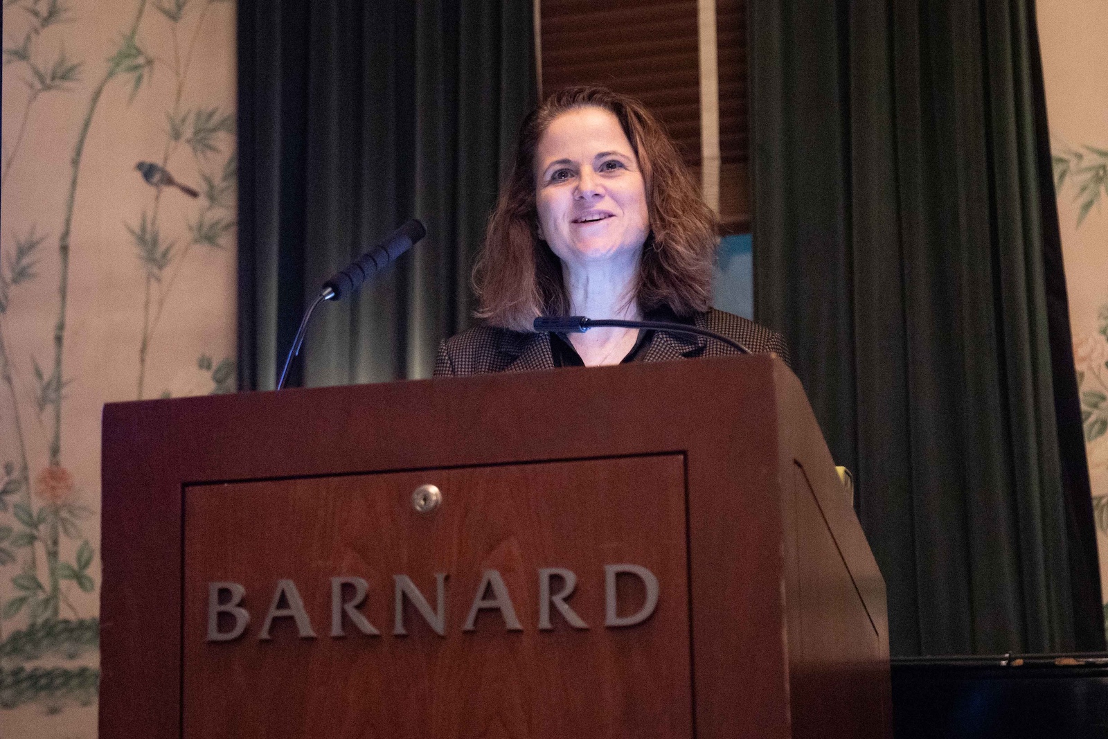 Woman stands at  podium