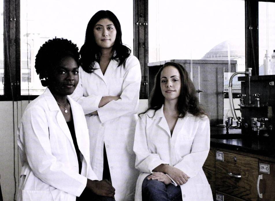 Three Barnard students in white lab coats.
