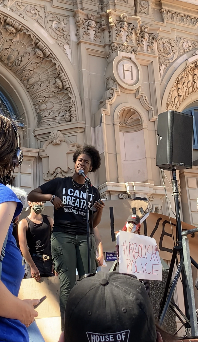 Sabrina McFarland speaking in front of the protest crowd in San Francisco