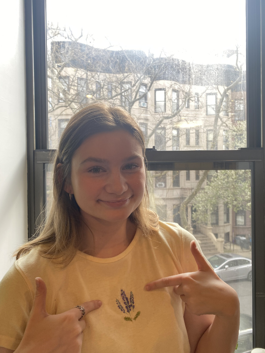 Jade Wilson wearing a yellow tshirt she embroidered flowers on.