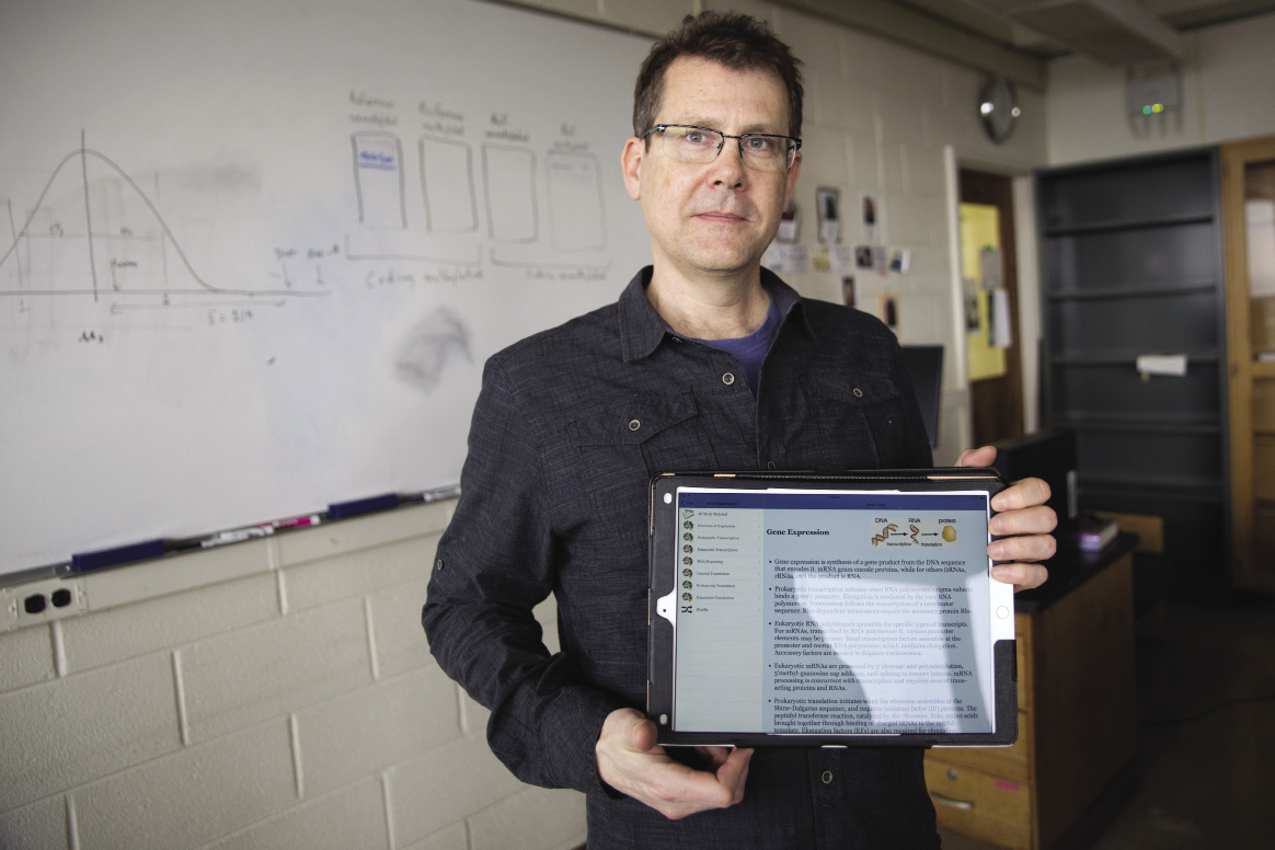 Brian Morton holding up a tablet